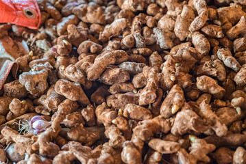 Many ginger roots on the counter of food market in Zanzibar, Tanzania.