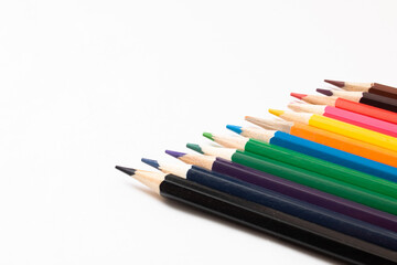 Pile of colored pencils on white background