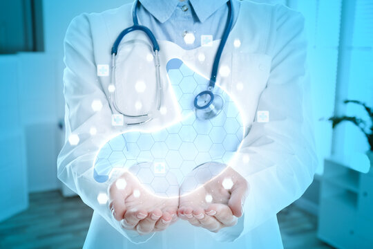 Gastroenterologist holding virtual image of stomach indoors, closeup
