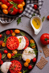 Caprese salad, tomatoes with mozzarella cheese and basil. Healthy vegetable meal