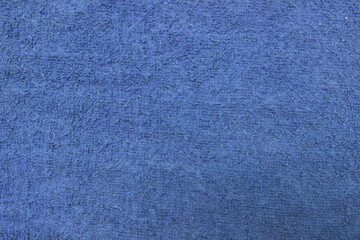 Texture of a blue terry towel close-up. Cotton fabric.