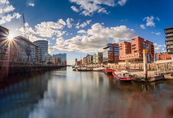 Hamburg view to the Sandtorhafen area with bricked wall buildings and sunlight with blue sky