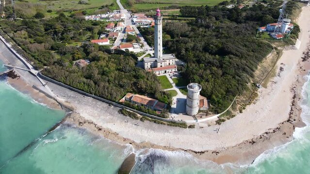 Aerial fly over drone footage of the Phare des Baleines or Lighthouse of the Whales taken from the sea on Ile de R&eacute; or island of Re France