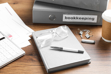 Bookkeeper's workplace with folders and documents on table