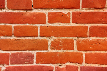 Obraz premium Background of a red brick wall with cement seams.