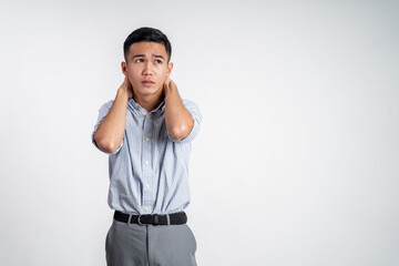 asian young businessman holding his head feeling unsure over isolated background