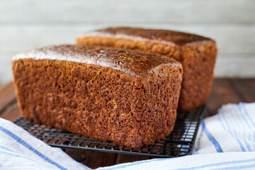 Freshly baked homemade rye bread on a textile background. Close-up, selective focus