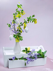 spring composition flowering branch with easter eggs, easter tree and spring flowers
