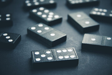 Black dominoes on dark table background