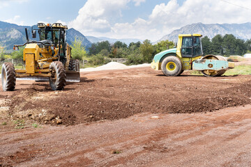 Grader Road Construction and Road compactor machinery. in excavation, vibratory road construction, earthworks and construction of new roads.