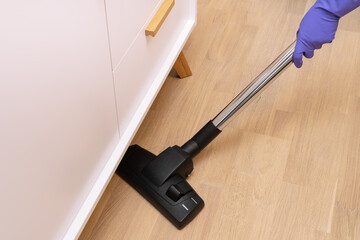 Vacuum cleaning floor in the room.
