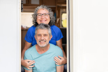 portrait of a gray-haired retired couple looking at the camera and smiling