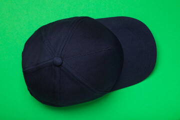 Baseball cap on green background, top view. Mock up for design