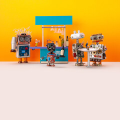 Toy party in a robot bar. A robot bartender, a bot waiter and mechanical cyborgs against the background of a bar counter and an orange wall. Template of restaurant business with drinks, service. free