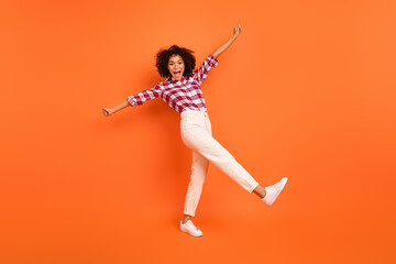 Fototapeta na wymiar Full size photo of cool curly lady yell wear shirt pants shoes isolated on orange background