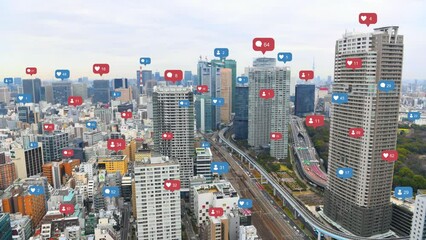 Aerial view of Tokyo cityscape with social media and notification icons pop up over the cities. Social media and Technology concept. - Powered by Adobe