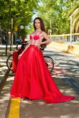 beautiful girl in a red dress on the street
