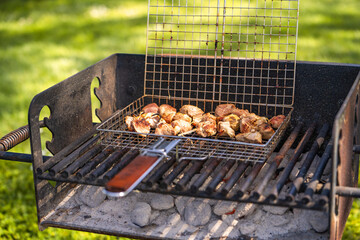 Pork skewers are cooked over an open fire. 