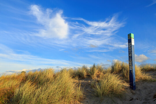 A beach access sign in dune grasses at a beach in the Bay of Plenty,  New Zealand