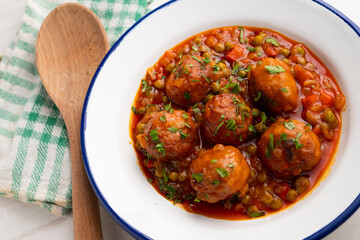 Veal meatballs in sauce with peas and tomato. Traditional Basque country tapas in the north of...