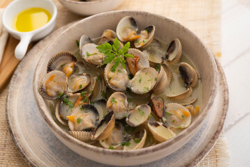 Cockles cooked in green sauce. Traditional Basque country recipe. Spanish cover.