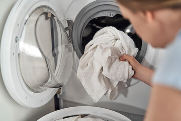 Close up of caucasian woman making laundry at home