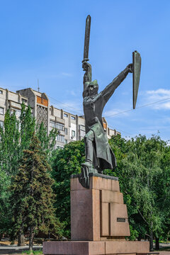 Mykolaiv, Ukraine - July 26, 2020: Monument to the dead policemen in Mykolaiv, opened in 1977. Male sculpture with a sword and shield stands on a granite pedestal against the backdrop of a green park