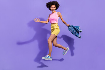 Fototapeta na wymiar Full length body size view of attractive cheerful thin girl jumping going motion isolated on bright violet purple color background