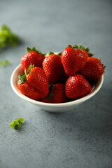 Fresh ripe strawberry in a white bowl