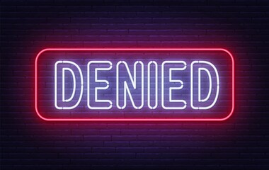 Denied neon sign on brick wall background