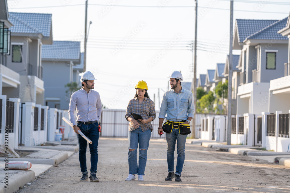Poster engineer and architect discussing building plan at construction site,group of builders having conver