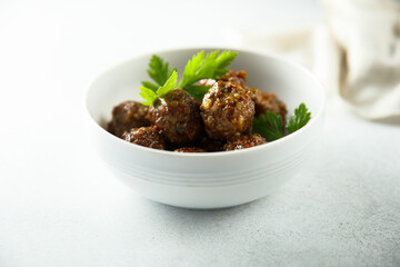 Homemade meatballs in a white bowl