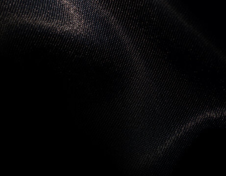 Black shiny polyester fabric background for graphic design, banner, poster.