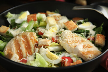 Delicious Caesar salad in bowl, closeup view