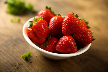 Fresh ripe strawberry in a white bowl