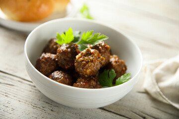 Homemade meatballs in a white bowl