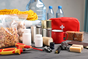 Disaster supply kit for earthquake on black wooden table indoors