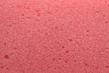 Pink cleaning sponge as background, top view
