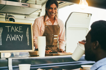Hispanic mature woman serving take away food inside food truck - Main focus on chef hands