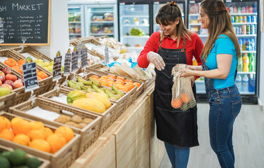 Female customer buying organic food fruits inside eco fresh market - Focus on right woman hands