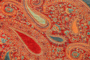 Colorful blue and red indian floral paisley pattern closeup, full frame