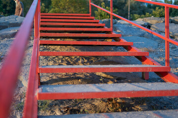 Fototapeta na wymiar Beach stairs with red metal railing