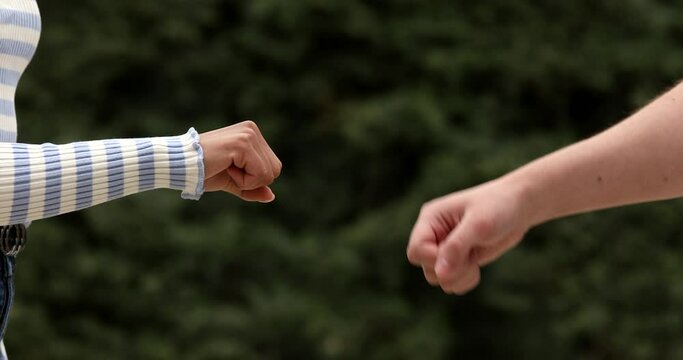 Business concept of teamwork. Close-up of the fists touching the symbol of a successful transaction, cooperation. Two successful people shake hands.