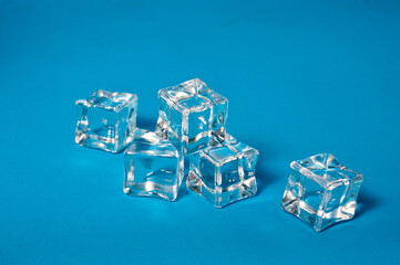 Clear ice cubes for cooling drinks on a blue background.