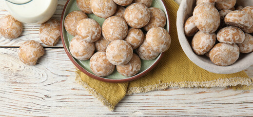 Tasty homemade gingerbread cookies on white wooden table, flat lay. Banner design