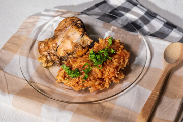 Bowl of east African Jollof Rice garnished with pieces of roasted chicken