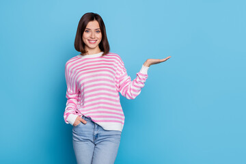 Photo of lovely millennial lady stand hold promo wear shirt jeans isolated on blue background