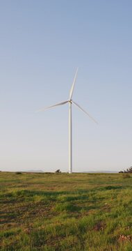 Vertical shot of a wind turbine in a countryside
