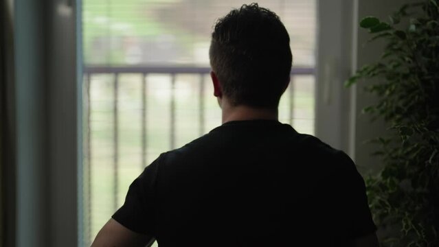 Lonely man silhouette watching through window enjoying view 4K