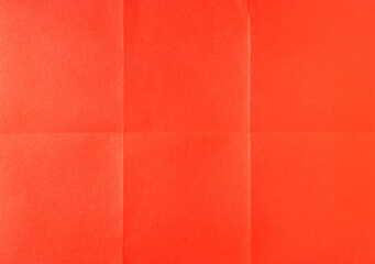 Fototapeta premium Red crumpled unfolded paper sheet texture background. Paper folded in six. Full frame